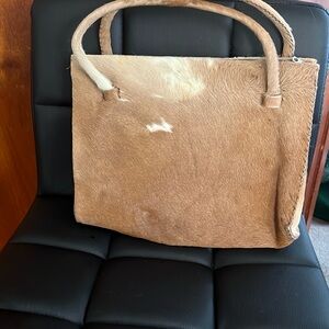 Tan cowhide or "hair-on hide" leather handbag